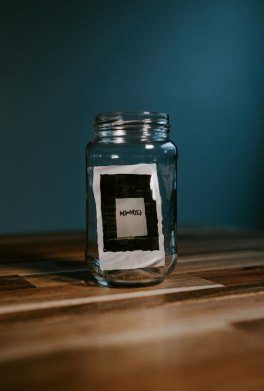 A glass jar containing an instant photograph labelled “memories.”